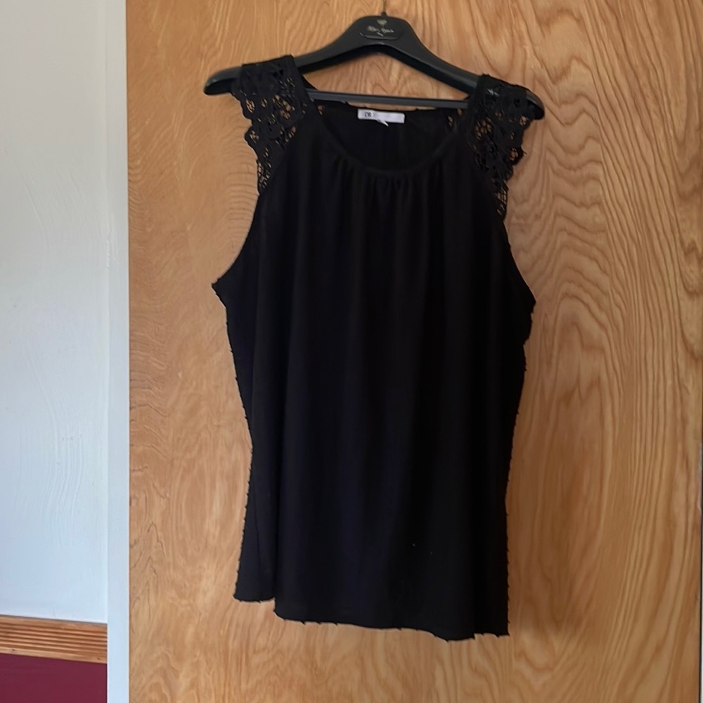 Plus size top with lacy shoulder detail.